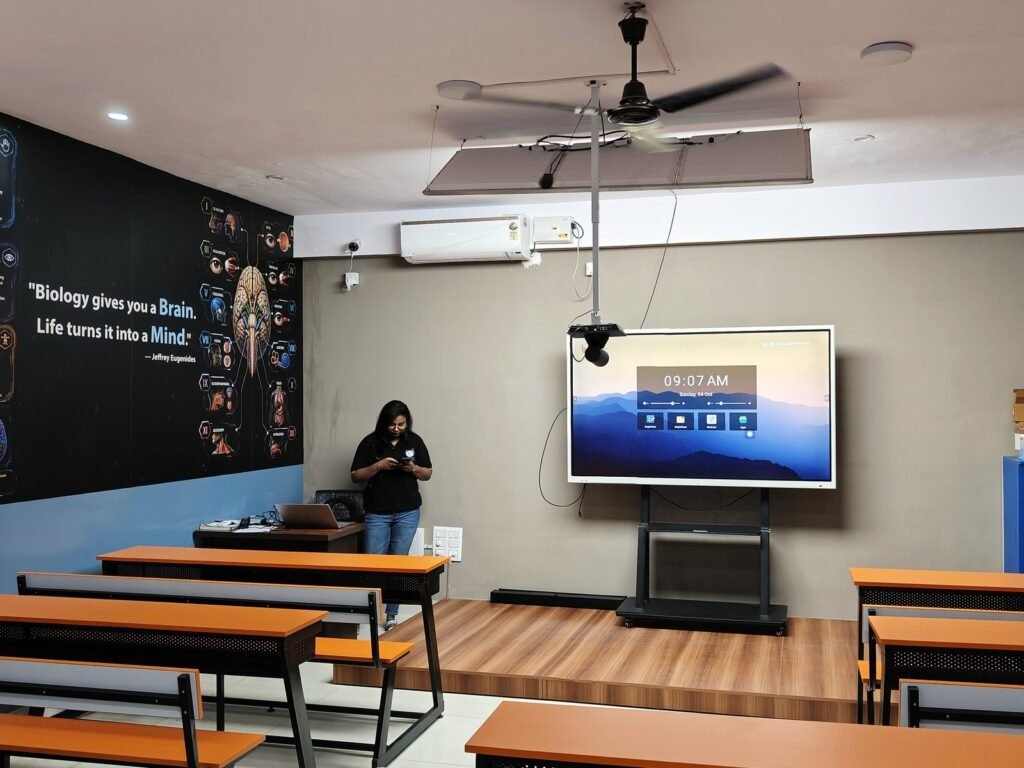 A classroom at the Chakravyuh Science Academy Budigere Cross branch, with a biology wall display and a large teaching screen